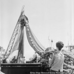 Fishing nets piled on Embarcadero near docked tuna boat Starcrest