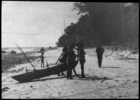 People on the shore with a canoe