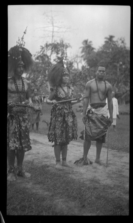 Three individuals with traditional Samoan clothing