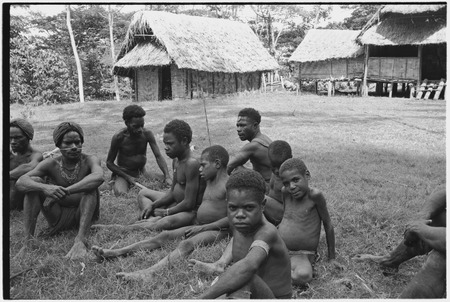 Dispute in Tuguma: men and boys near government rest house, awaiting dispute