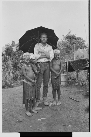 Edwin Cook and children, including Kotsbuka, under an umbrella
