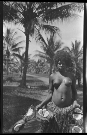 Woman holding cut coconuts