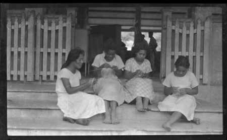 Cook Islands girls weaving on the steps of the school