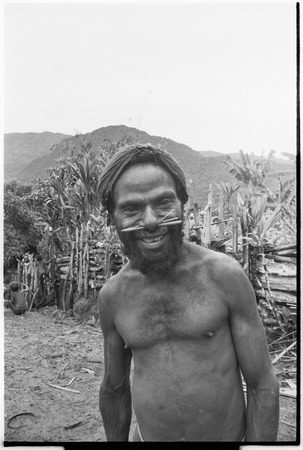 Man with barkcloth cap and pierced nose