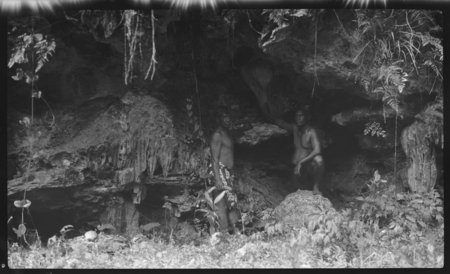 Maka, son of Rongomatane, and another man in Atiu cave, showing symbols of Maui, made by the god Tangaloa