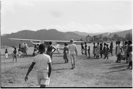 Wanuma: airplane and crowd of people on mission&#39;s landing strip