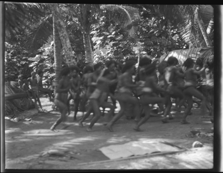 Group of men, dancing in ritual activity