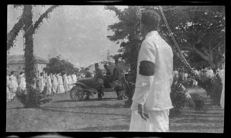 Tongans saluting men in vehicle