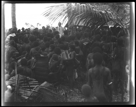 Group of Solomon Islanders surrounding European man