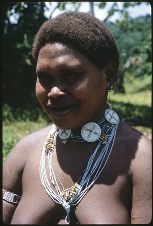Woman&#39;s portrait, with white beads and string of girimalaile pendants.
