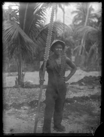 Kiribati man with traditional armour and weapon