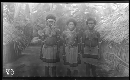 Portrait of three young Santa Ana women wearing Cloth skirts and traditional necklaces, armbands, and headbands