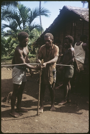 Setting up cross-stick from which to hang shell money from for a bride price.