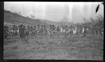 Men of Mambare area dancing in costume, at a gathering