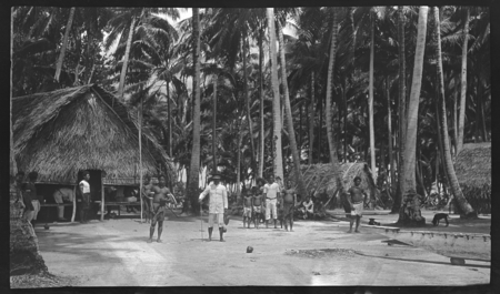 Men and boys near dwellings, Ninigo Islands