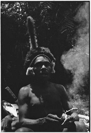 Pig festival, uprooting cordyline ritual, Tsembaga: in ancestral shrine, man speaks to red spirits and smoke woman, spirit...