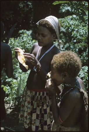 Women eating what appears to be melon.
