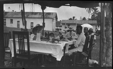 Cook Islanders and unidentified Europeans eating a meal