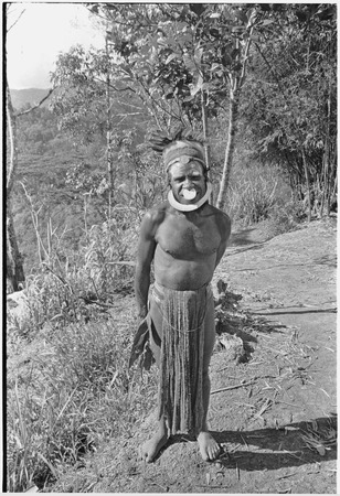 Man wearing luluai badge, headdress, nose disc and shell valuable