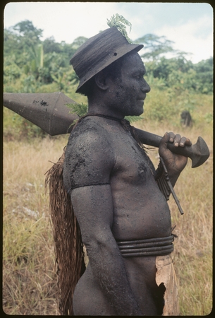 Basiitau painted black, wearing his very old cane hat.