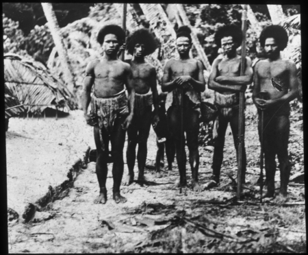 Group of men, some holding spears
