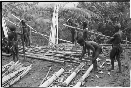 House-building for Rappaports: men with steel axes prepare lumber for frame