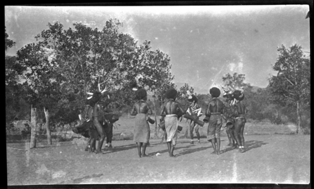 Motu men in circle, drumming and dancing near a dubu platform at Gaile, also spelled Gaire, a village in Central Province