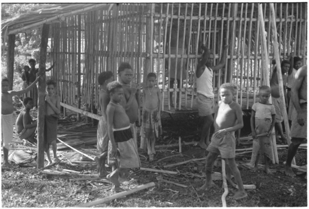 Group of people in front of house under construction.