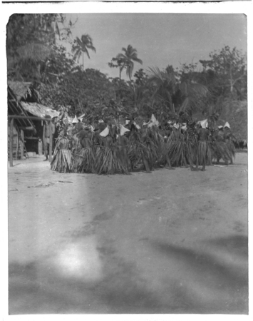 Santa Catalina dancers with leaf skirts and conical hats