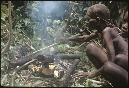 Mamaniageni and old Boori&#39;au cooking in some bamboos.