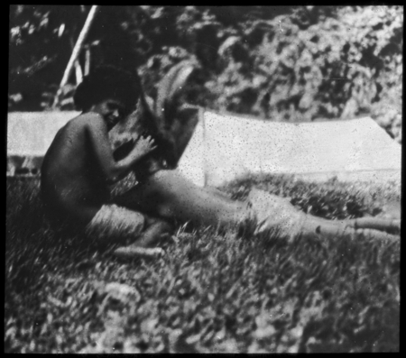 Two people laying on the grass