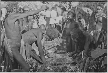 Returned laborers, purification ritual:: Mauwi bespells the cooked food