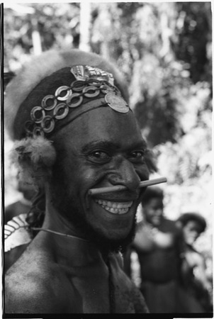 Gunts: smiling luluai (government appointed leader) with nose ornament, marsupial fur and shell-ring headdress
