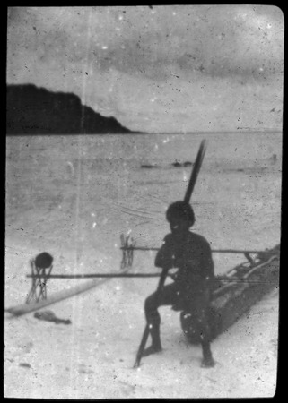 Man holding paddle, and sitting on canoe