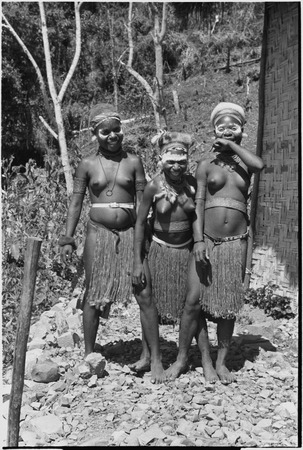Adolescent girls (Kopi, Kanila, and Kena) laughing, next to Cooks&#39; house in Kwiop
