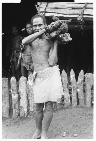 Man carrying pork on shoulder.
