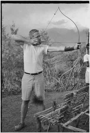 Edwin Cook practicing archery near his house in Kwiop