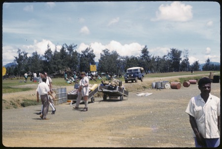 Mount Hagen: cargo and people by edge of airstrip