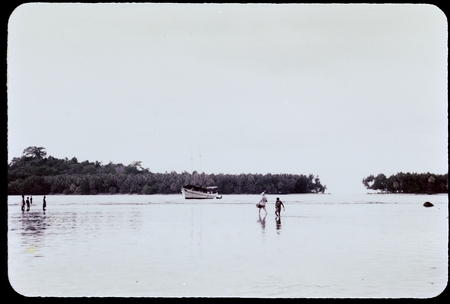 Boat and people on a reef