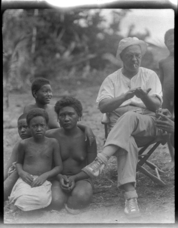 Sylvester Lambert sitting with women and children