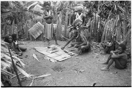 Pig festival, pig sacrifice, Tsembaga: ritual exchange of shell valuables, steel axes, and pork displayed on mat