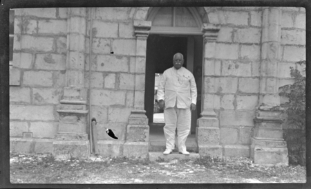 Portrait of man standing on doorstep of building