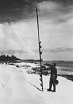 Francis Shepard and geology class design a suspended sediment trap for the  study of sand transport onto the beach. Nets were made from the toes of  wives' nylon stockings. L-r: Donald Sayner