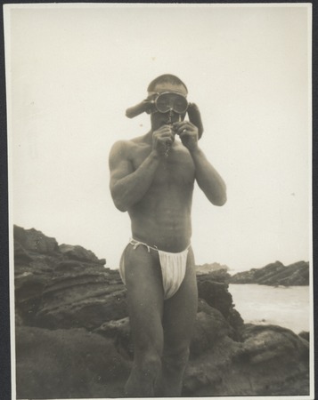Seaweed diver wearing face mask with pressure equalization air chambers, for mask squeeze. Japan, c1947