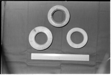 Three shell ring valuables, shown with ruler for scale
