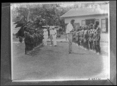 Men and children lined up for an assessment