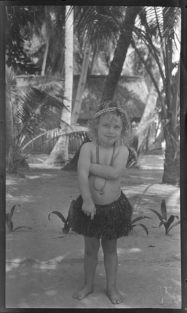 Young girl, possibly Sara Lambert, in grass skirt