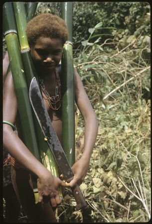 Woman carrying water bamboos.