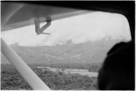 Madang-Aiome flight: burned kunai grass, Ramu River Valley and Schrader Range, aerial view