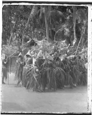 Santa Catalina dancers with leaf skirts and conical hats